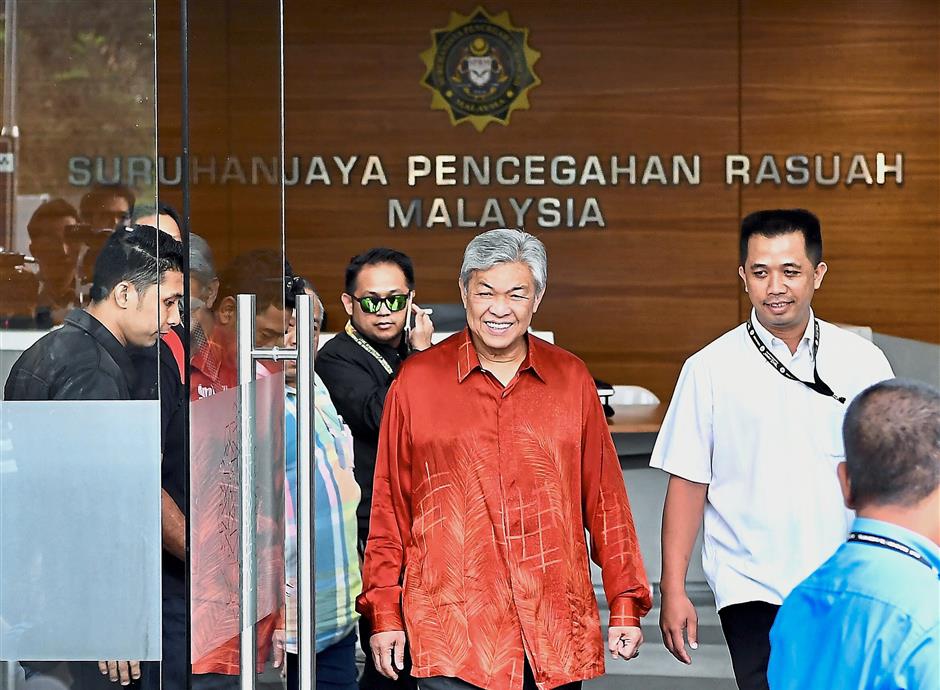 Question time: Dr Ahmad Zahid leaving the MACC building after being questioned in Putrajaya. — Bernama