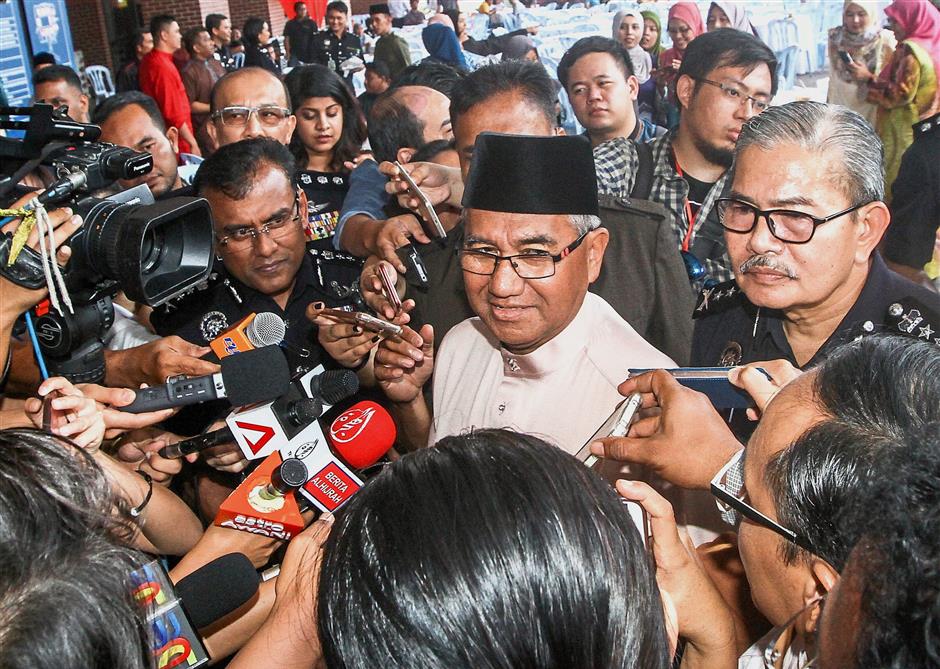 Questions: Mohamed Fuzi speaking to reporters at the Home Ministry’s open house in Putrajaya.