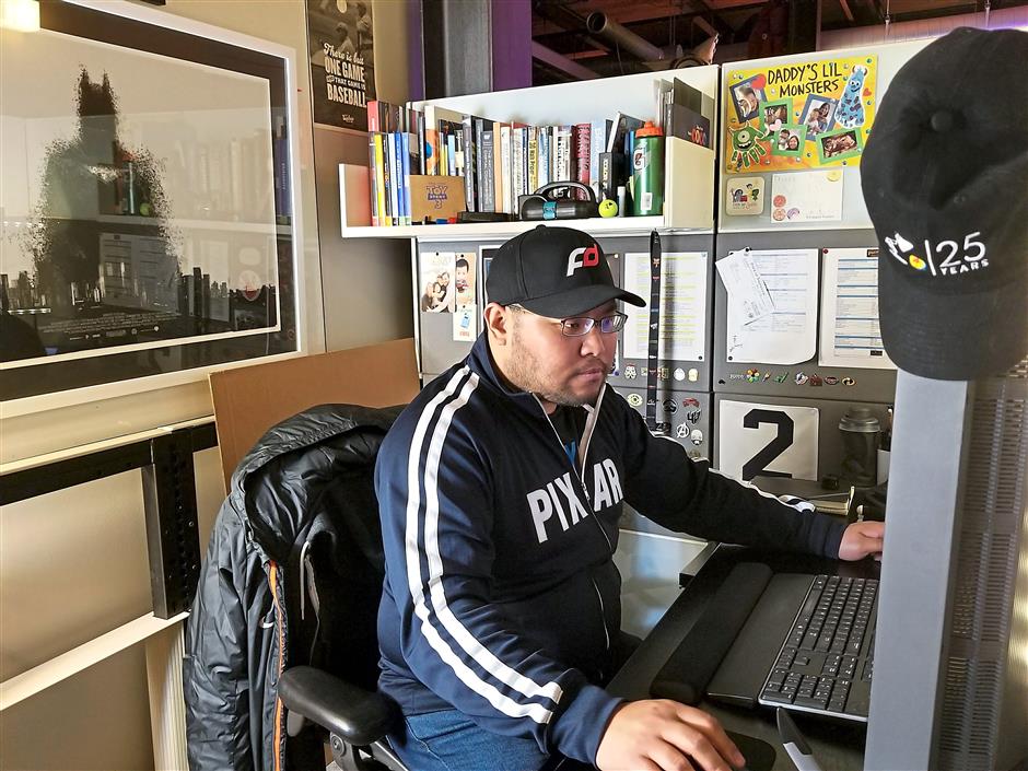 Liew at his desk at Pixar studio in California. As a simulation technical director, he is in charge of bringing clothing and other props to life. — LYON LIEW