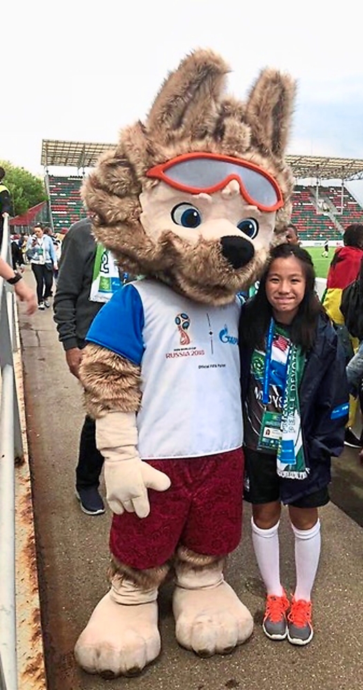 Lauren posing for a photo with Zabivaka, the official World Cup mascot.