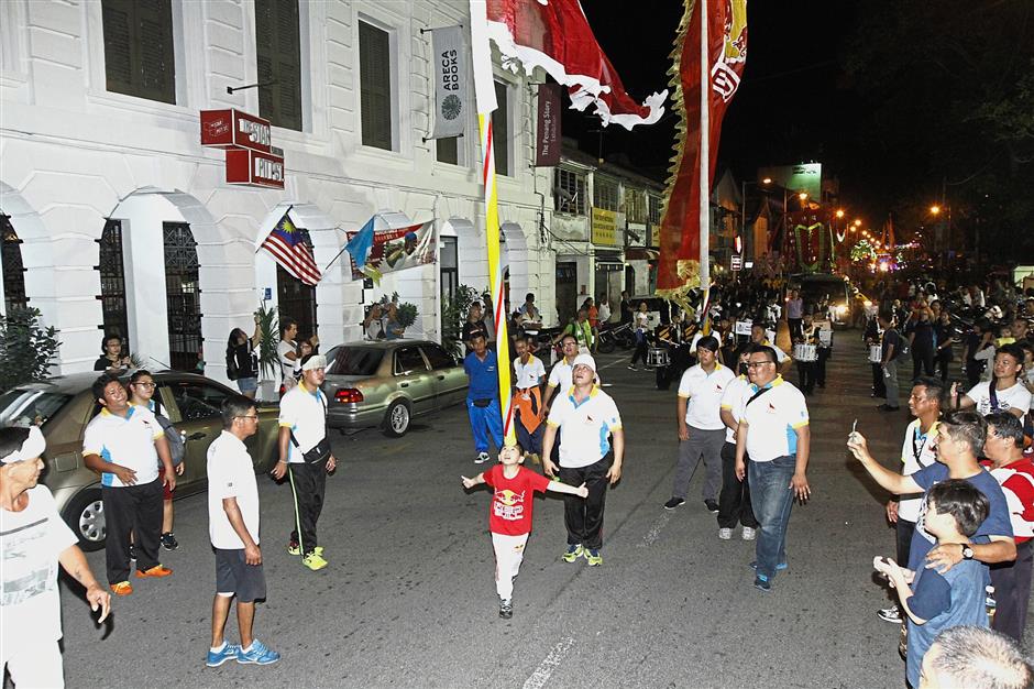 Adrian showing off his spunk by balancing Star Media Group’s giant flag pole on his forehead.