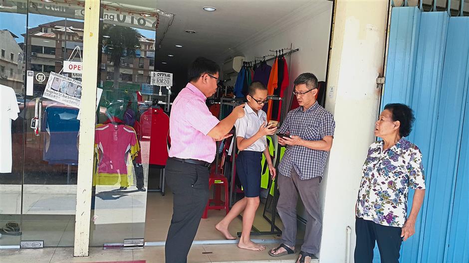 Leong (left) having a word with Jimmy Tan (third from left) regarding the break-in at the premises in Taman Bayu Perdana, Klang.