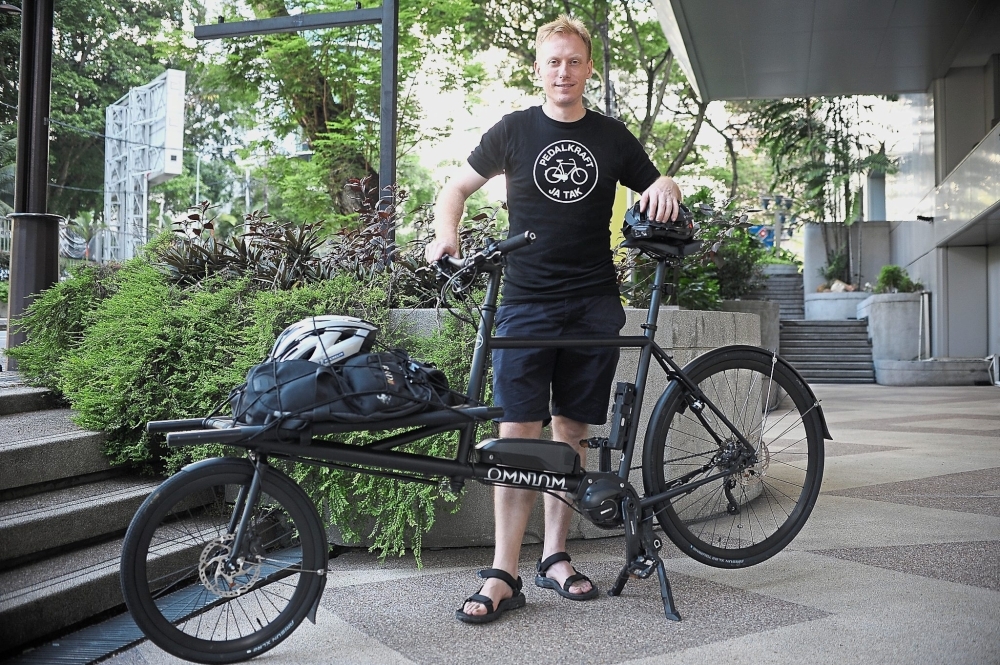 Reimann with his Omnium electric cargo bicycle with 250 watt pedal-assist motor says the bicycle imported from Copenhagen is great for when he needs to carry cargo, as it can carry up to 100kg.