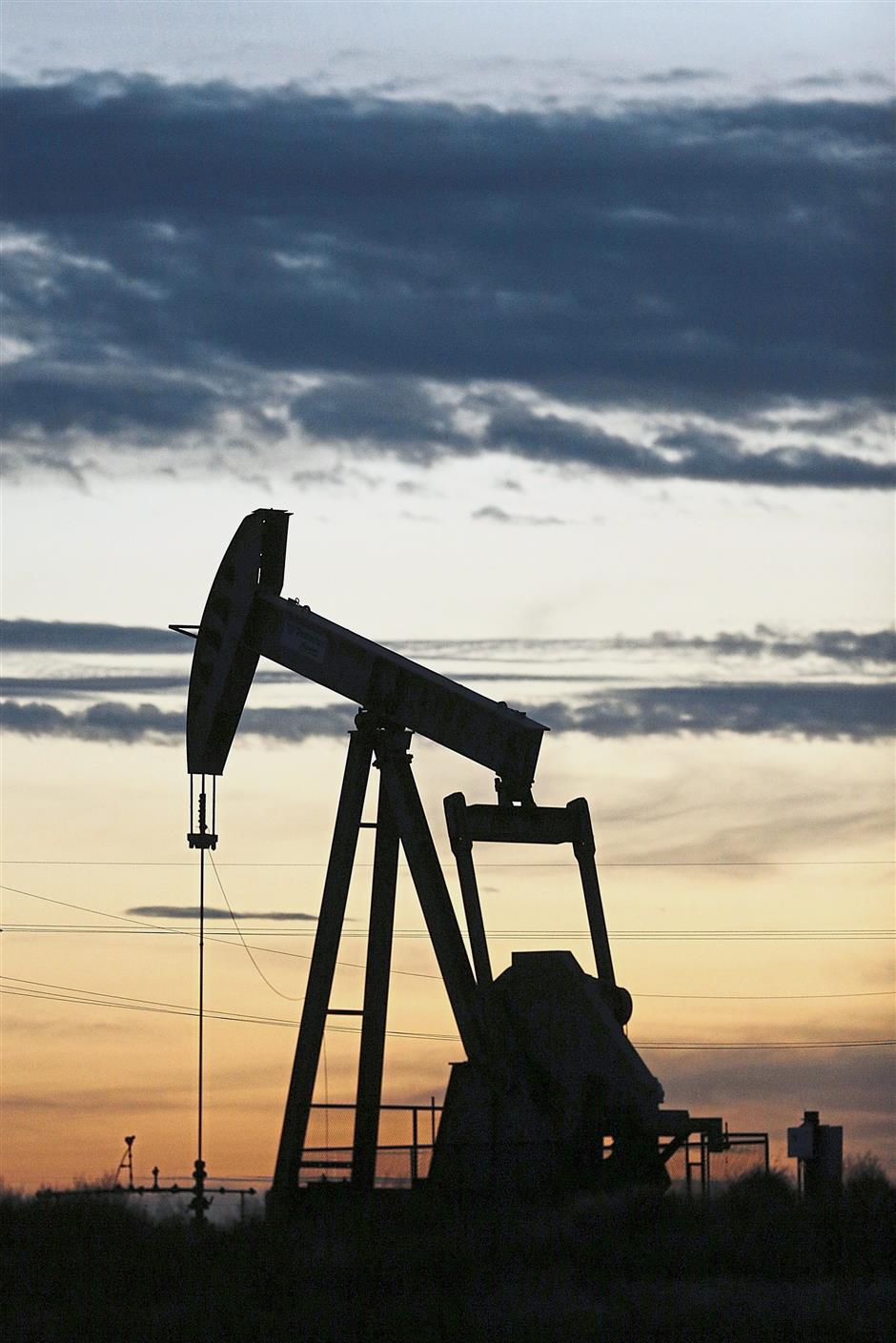 Tough operating environment: The silhouette of an electric oil pump jack is seen at dusk in the oil fields surrounding Midland, Texas. Sapura Energy has been eking out profits in the majority of quarters since the collapse of crude oil prices in late 2014. — Bloomberg