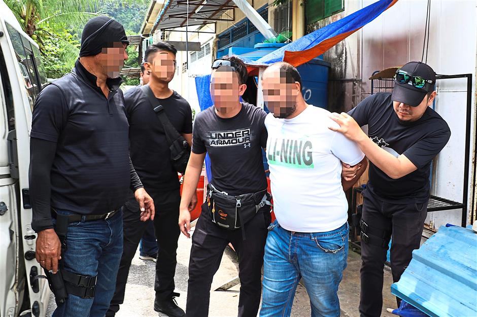 No more place to hide: Counter Terrorism Special Unit officers apprehending a suspected militant during several raids made in Klang Valley and Serian in Sarawak. Nine individuals aged between 20 and 54 were arrested during the raids. — Bernama