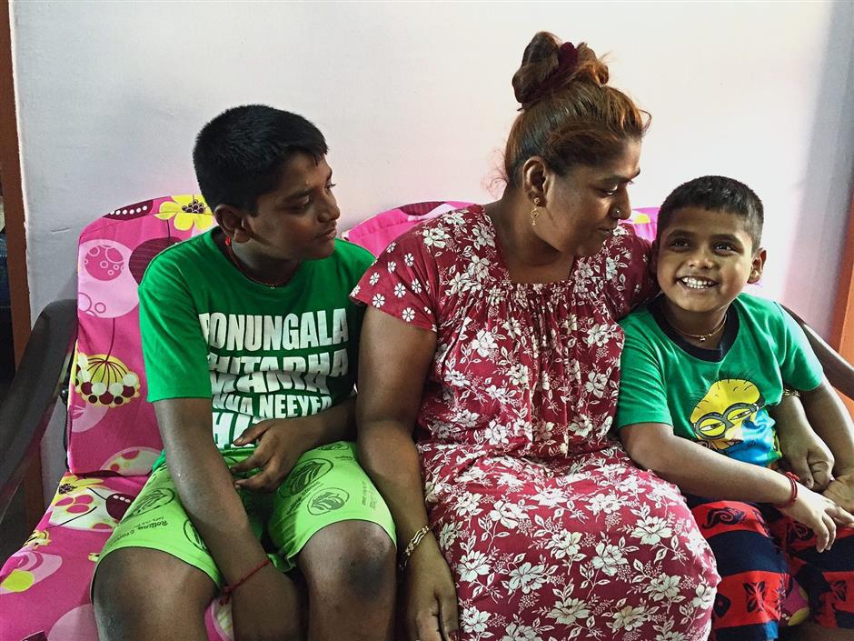 Uma Devi with her two youngest children Rishi Mean Muniandy, 12 (left) and Gunaraj Muniandy, six. Her familys life was upended when her husband and sole breadwinner passed away two years ago.