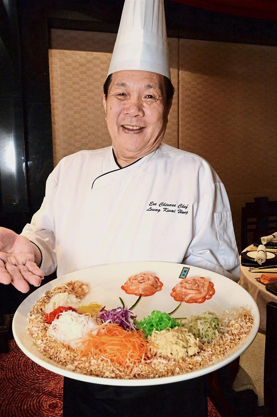 Head Chef Leung Kwai Hong proudly showing off the Yee Sang at Ritz-Carlton KLs Li Yen restaurant.