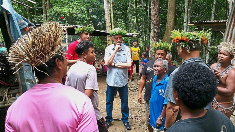 Getting it from the source: Heller (middle) in Gua Musang, learning from the orang asli about the way they live, including their water woes and sanitation problems.