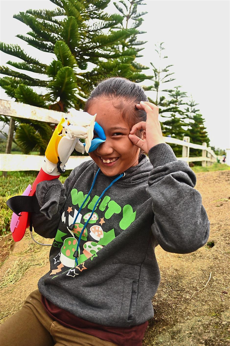 Nas Viya Syazana Alyvictor, 11, is one of the young recipients of the donated prosthetic arms made by Sujana. — Sujana REJAB