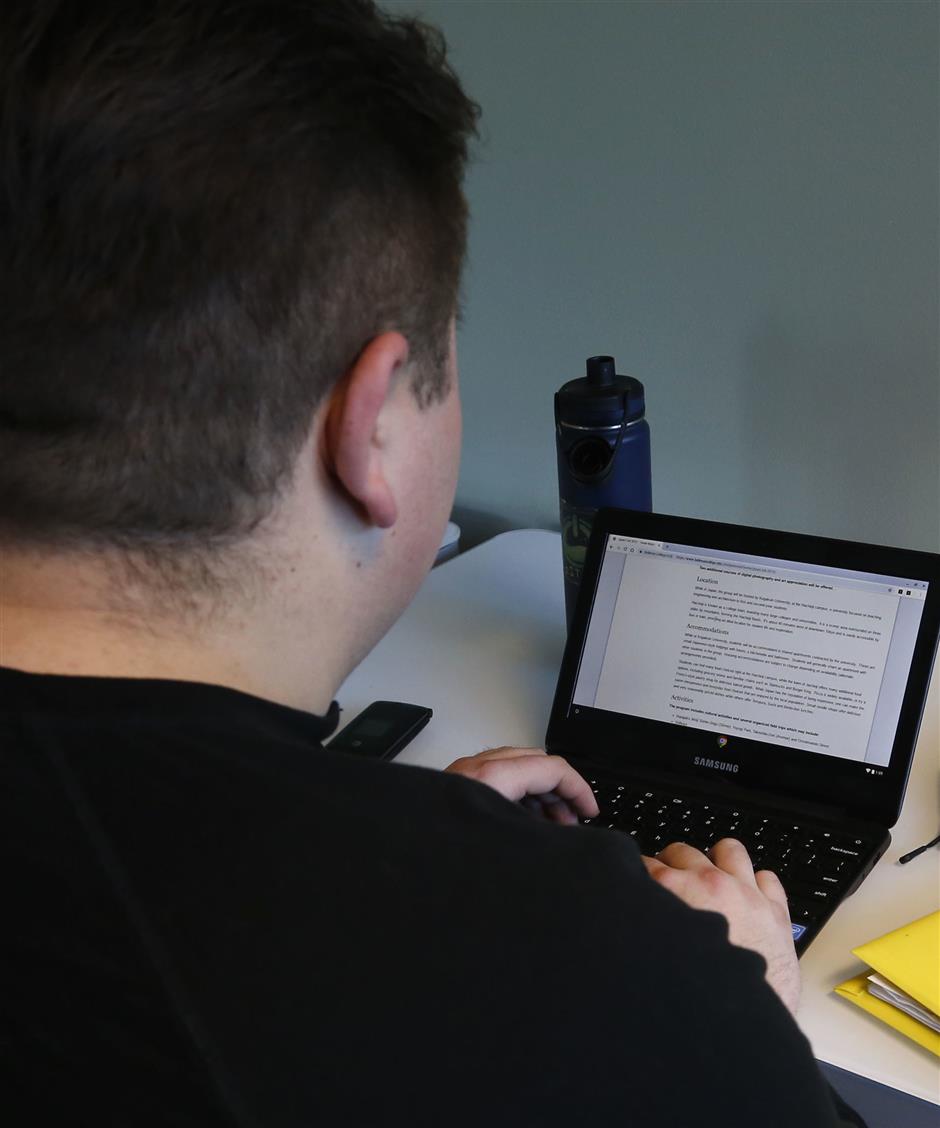 In this Monday, Dec. 10, 2018, photo, Jason, a 24-year-old tech addict from New York state, works on a laptop in Bellevue, Wash., at the headquarters of reSTART Life, a residential program for adolescents and adults who have serious issues with excessive tech use, including video games. Jason came to reSTART several months ago because excessive use of video games had become a problem. 'I knew I'd have to change or I'd end up killing myself,' said Jason, who is now living independently, has a job and is able to use some technology. He plans to start his first pre-med class, biology, in January. (AP Photo/Martha Irvine)