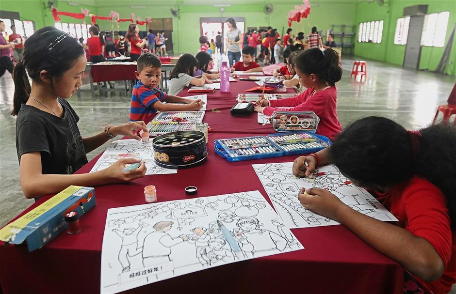 Children enjoying themselves at a colouring session in the school hall.