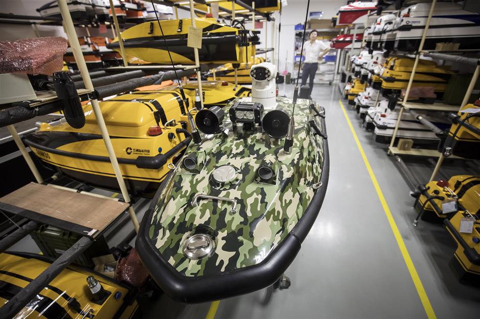An unmanned surface vessel in camouflage paint sits on a stand at an Oceanalpha Co. facility in Zhuhai, China, on Thursday, May 18, 2018. Oceanalpha, one of a handful of companies around the globe specializing in ocean-going drones that operate on the surface, has fired the interest of some of China's biggest venture capitalists. Photographer: Qilai Shen/Bloomberg