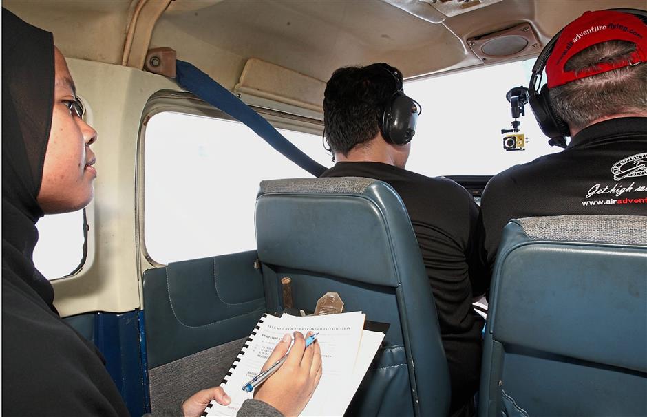 Hasnor Farah records flight data as the test pilot performs specific maneuvers during the flight testing.