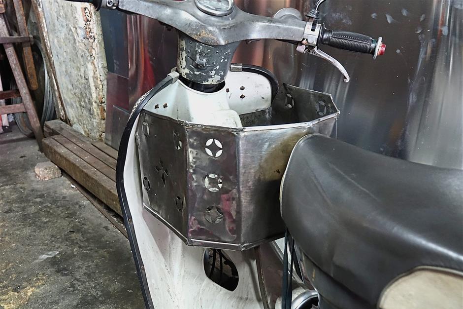 Low has added his personal touch to the utility basket on his old motorcycle.