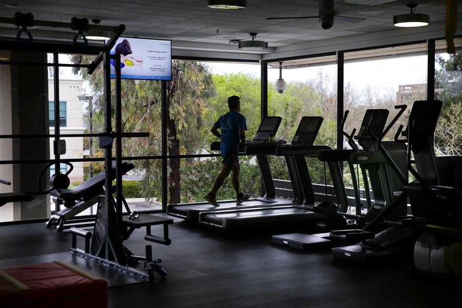 A man uses a treadmill in a gym connected to a physical therapy center at a Cisco health clinic at Cisco Systems in San Jose, California, U.S., March 22, 2018. Picture taken March 22, 2018. REUTERS/Elijah Nouvelage