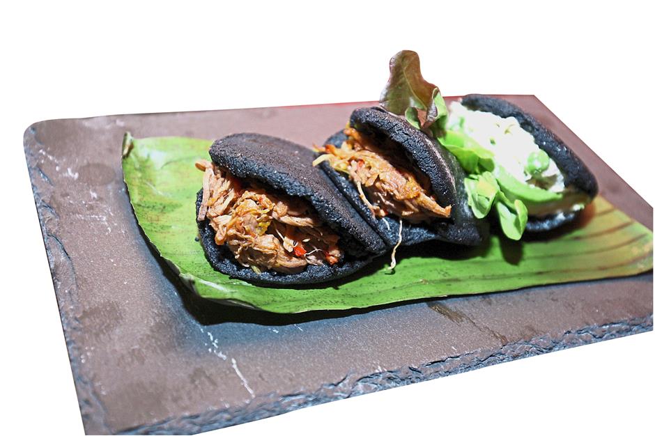 The Reina Pepiada is a charcoal arepa with a chicken and avocado filling.