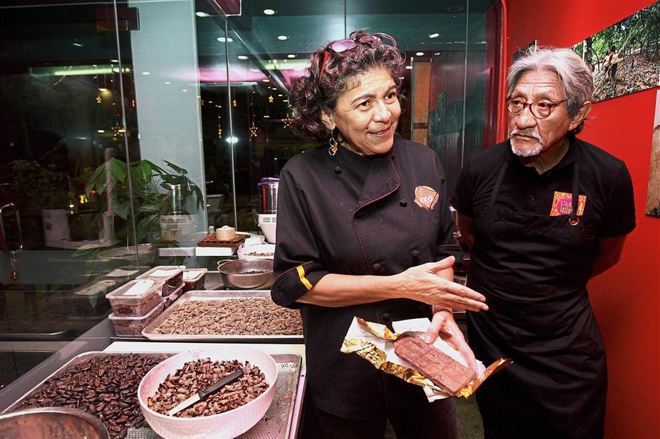 Rodriguez (left) explaining how chocolate is made at the cacao lab in Casa Latina. — Photos: FAIHAN GHANI/The Star