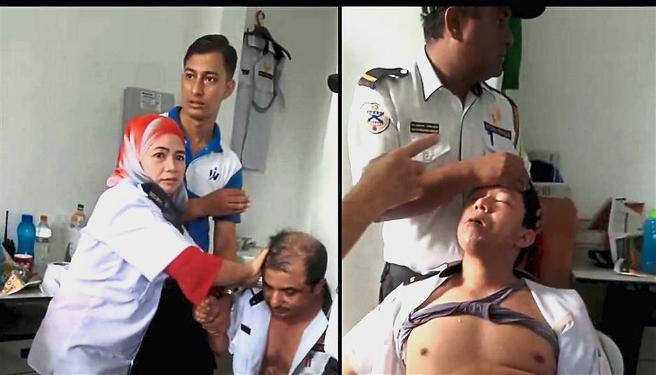 Unfortunate incident: A screenshot of the video showing security guards Bishnu Shrestha (right) and Sapkota Mangal Prasad being helped by their friends (from left) Hasmah, Chandra Khadka and Budhathoki Bhakta Bahadur during the incident at a condominium in Pulau Tikus.