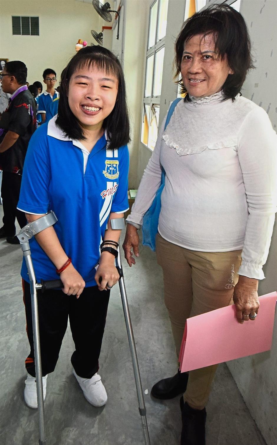 A beaming Pei Xuan (left) and her grandmother Chay were both overjoyed with her good SPM results.
