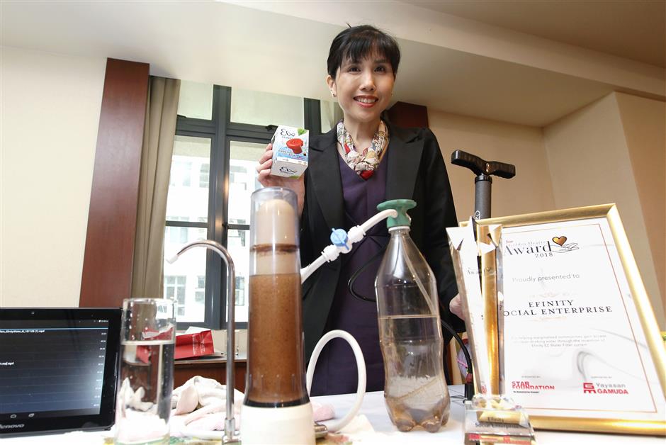 Useful device: Teng showing the Efinity EZ Water Filter system which was later used to provide marginalised communities with clean drinking water.