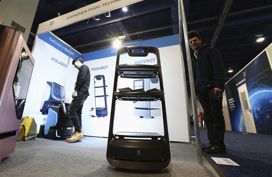 The Shenzhen Pudu Technology Co. Pudubot zips around while on display at CES International Thursday, Jan. 10, 2019, in Las Vegas. (AP Photo/Ross D. Franklin)