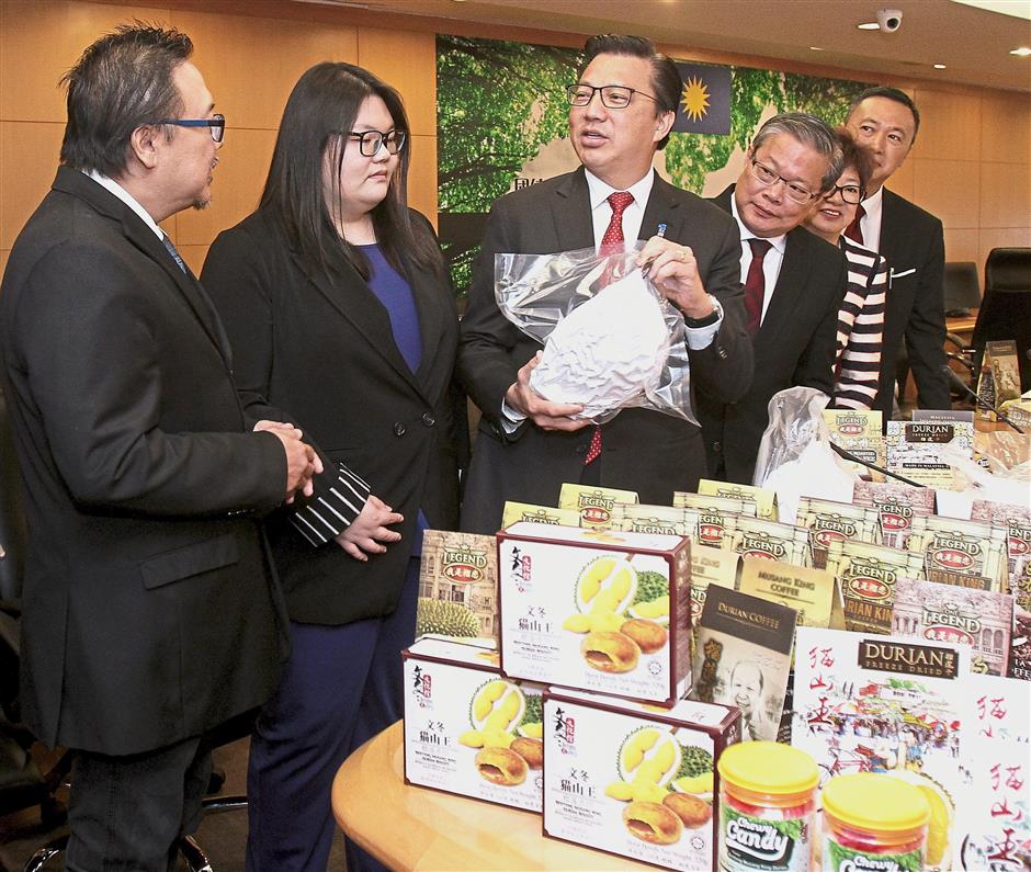 Sweet deal: Liow checking out the various durian products after witnessing the MOU signing ceremony between Malaysia and China.