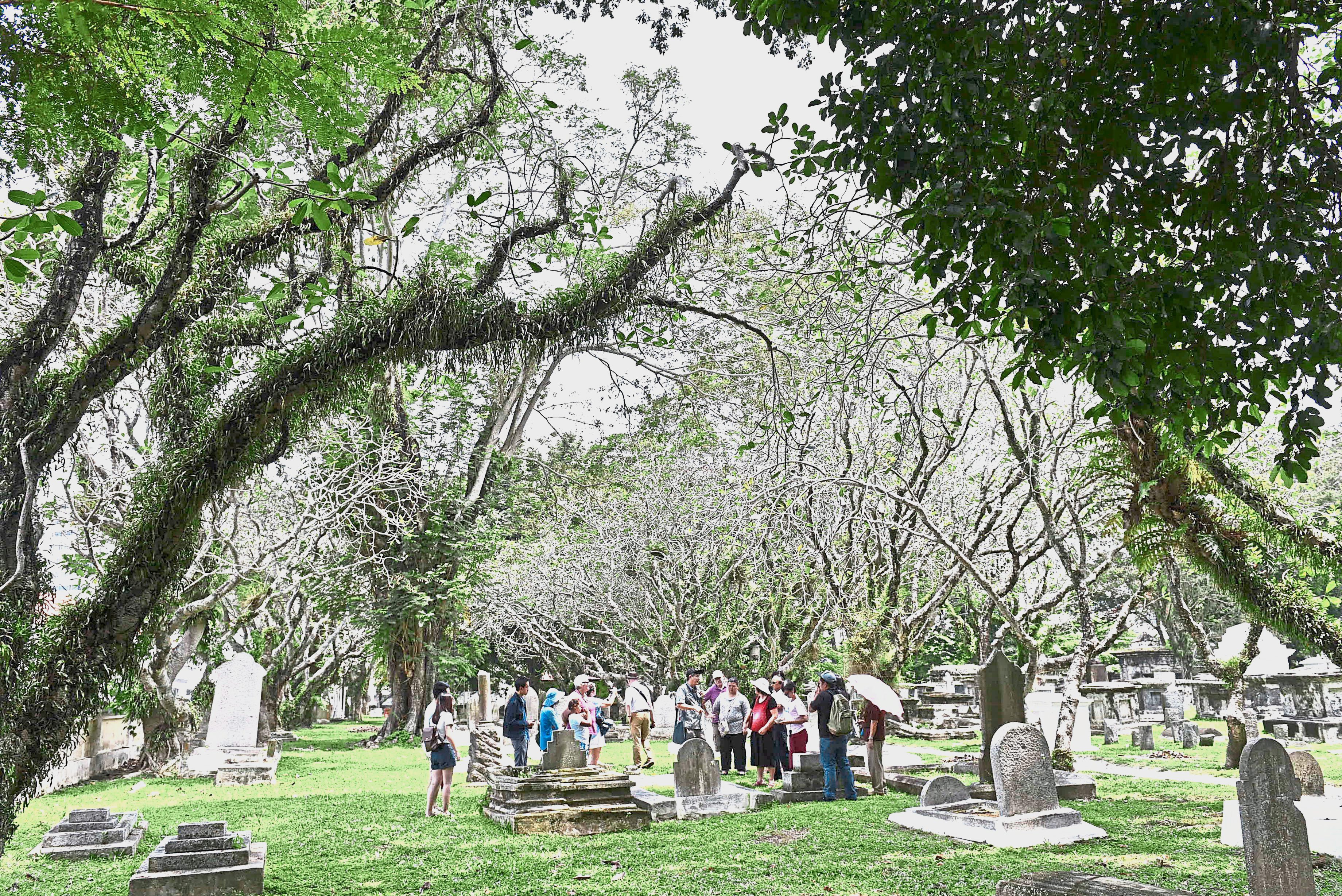 Visitors listening to stories about the illustrious personalities buried at the Protestant Cemetery in Jalan Sultan Ahmad Shah, George Town. — Photos: GARY CHEN/The Star