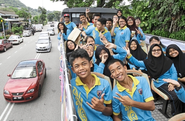 Students and teachers from the Federation School for the Deaf enjoying a ride on the Hop-On-Hop-Off bus during Tenby Schools Penang’s Spring Fair 2017 in Tanjung Bungah.