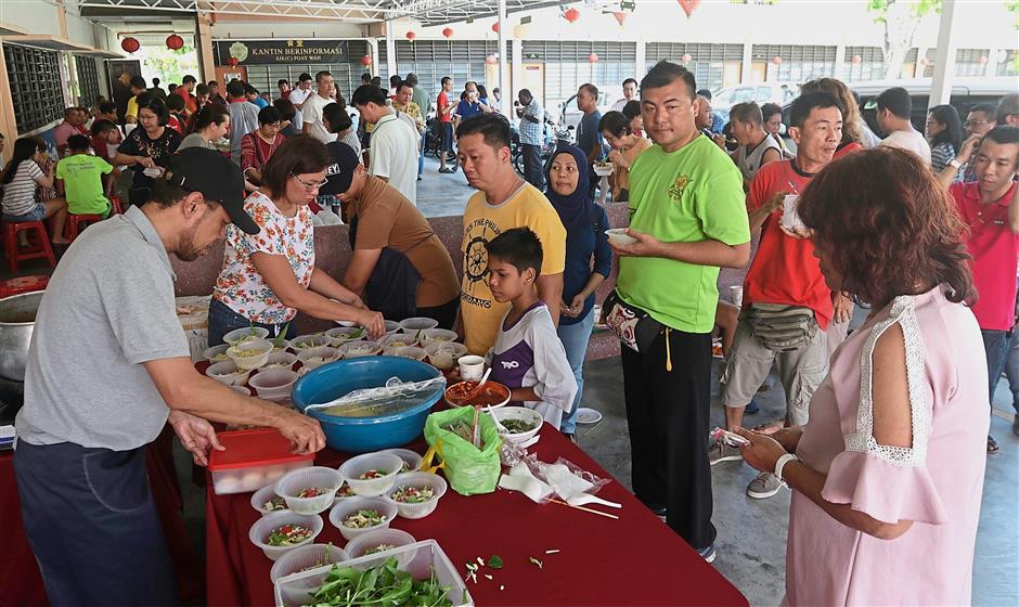 Visitors queuing up for a bowl of noodles at the CNY function.