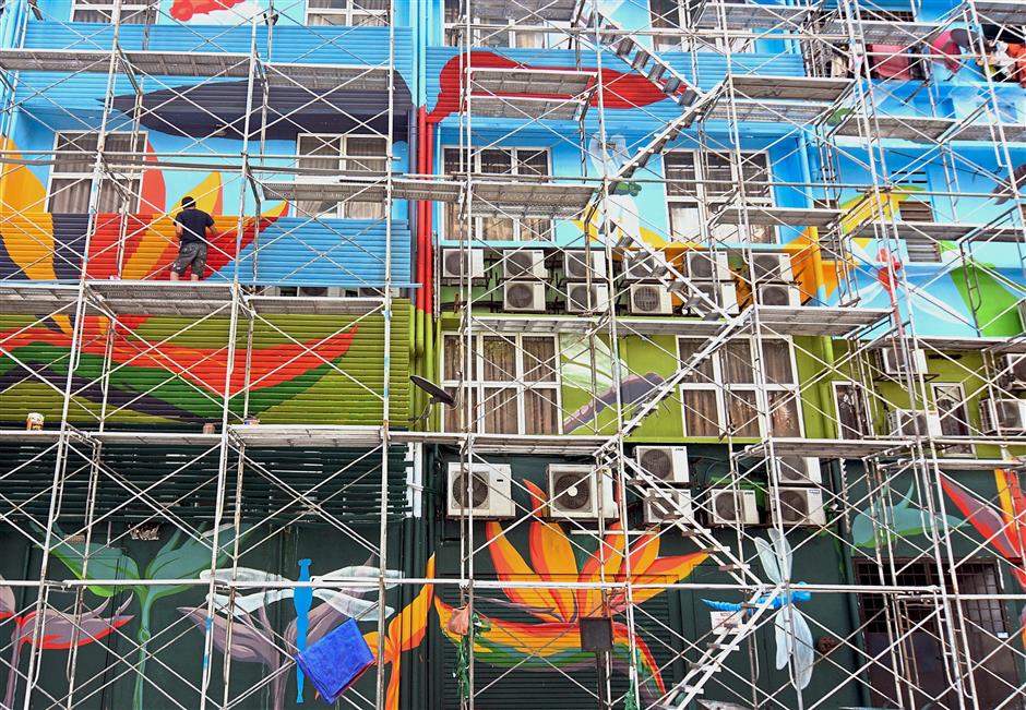 Heliconias and dragon flies decorate the back facade of buildings along Jalan Rembia. — Photos: P. NATHAN/The Star