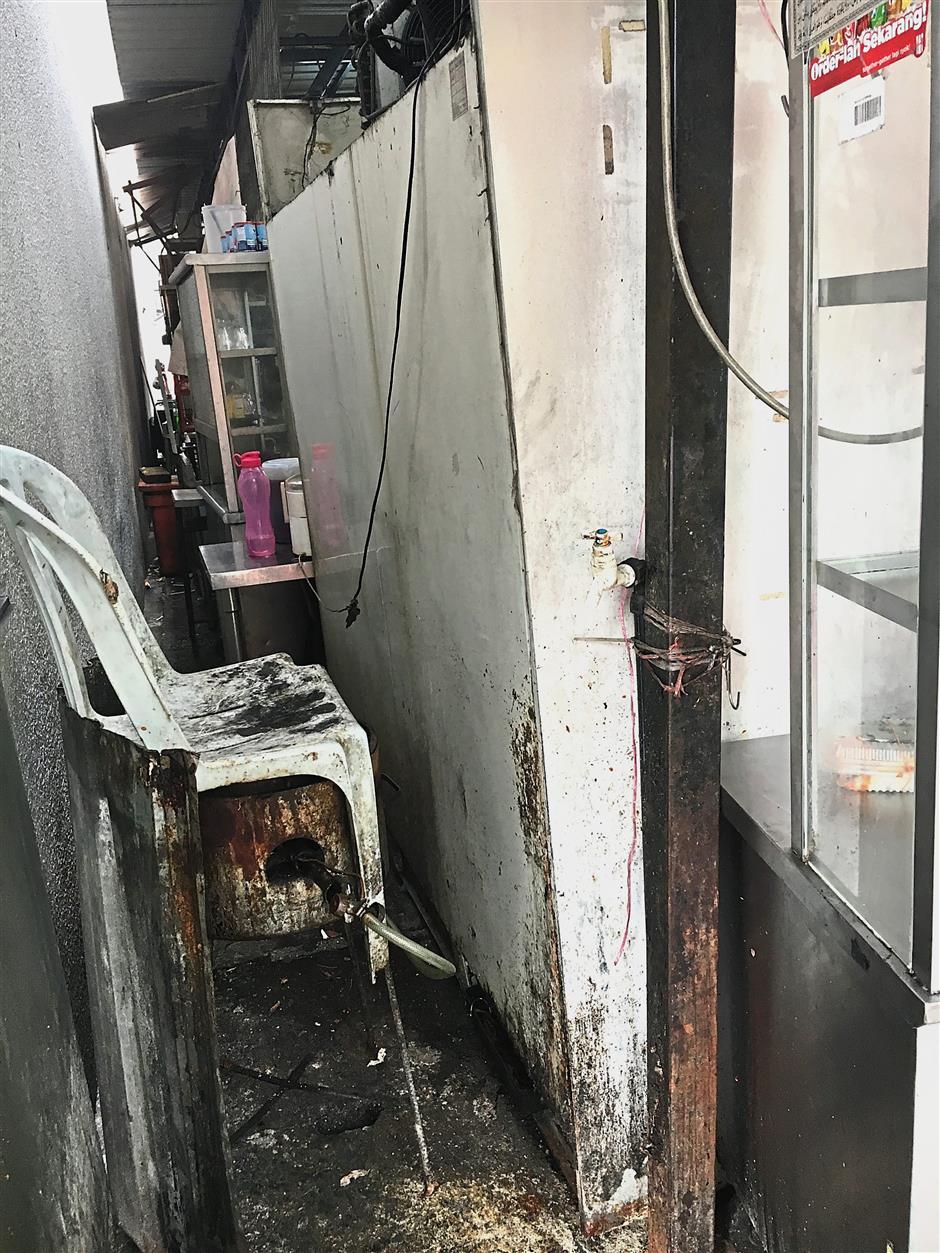 The filthy back portion of a stall in Brickfields that has been illegally extended and now looks almost like a restaurant.