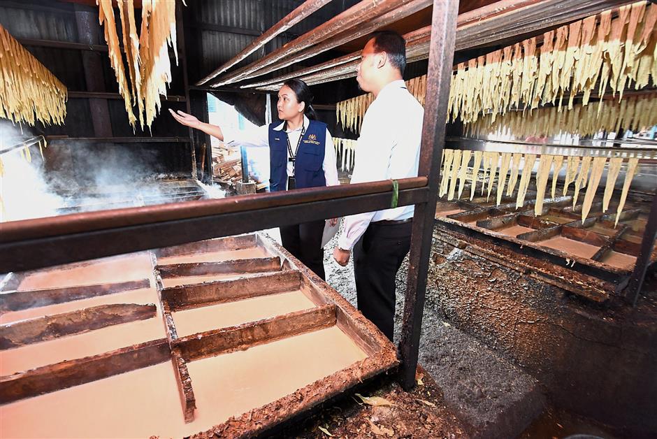 State Health Department enforcement officers checking the fucuk or tofu sheets made of soybeans at the factory during the ‘Operasi Penang Sihat’ in Juru, Bukit Mertajam. — Photos: MUSTAFA AHMAD/The Star