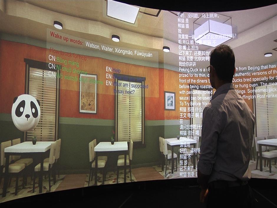 In this Aug. 22, 2018 image taken from video, Rensselaer Polytechnic Institute graduate student Rahul Divekar interacts with a panda avatar that helps teach students Mandarin at Rensselaer Polytechnic Institute in Troy, N.Y. The 'Mandarin Project' is a joint venture of RPI and IBM. Cognitive and Immersive Systems Laboratory researchers are developing a sort of smart room that can understand students' words, answer their questions and perceive their gestures. (AP Photo/Michael Hill)
