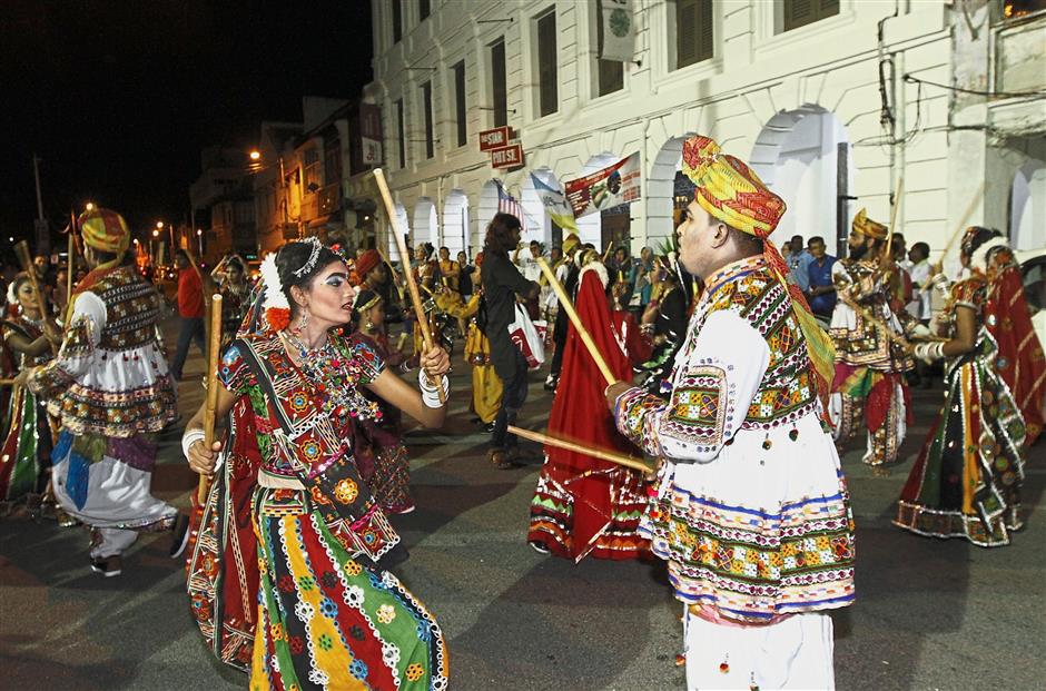 Members of the Indian dance troupe performing kolattam in front of The Star Pitt St. building in Jalan Masjid Kapitan Keling. — Photos: LIM BENG TATT/The Star