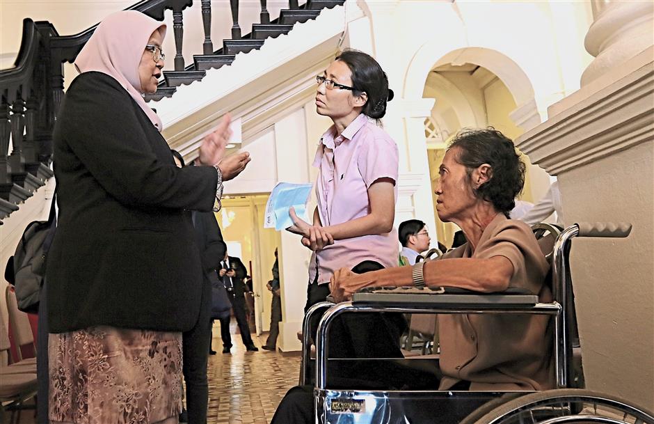 Getting a clearer picture: Maimunah explaining the situation to Ooi and her disabled mother Teoh at the MBPP building.