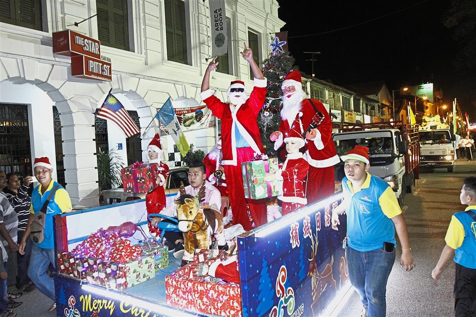 The Christmas-themed float spreading festive cheer to spectators during the Chingay parade in George Town.