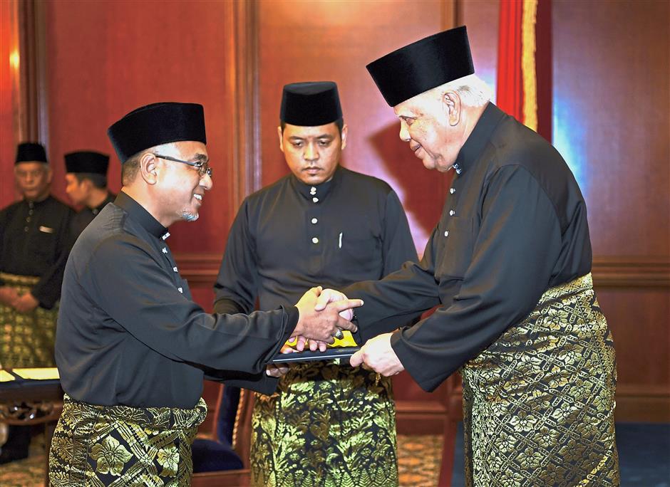 Melaka Governor Tun Dr Mohd Khalil Yaakob (right) presenting the letter of appointment to Adly after the latter was sworn in as Melaka Chief Minister. — filepic
