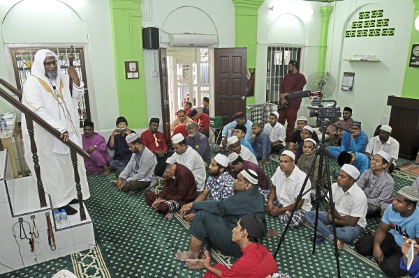 ^ Kamarudin            preaching his           sermon at the Tarik Air Mosque.