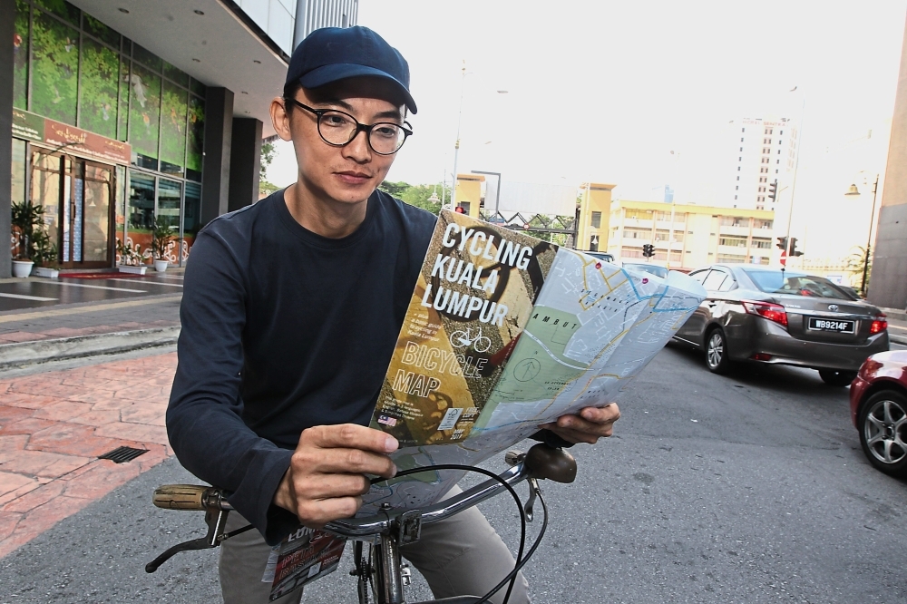 Lim worked with DBKL for more than six months to map out the dedicated bicycle lane route. (Right) A frequent complaint among cyclists is that cars and other vehicles park along the lane, forcing them to ride on the road. — Photos: KAMARUL ARIFFIN, P. NATHAN, MUHAMAD SHAHRIL ROSLI and AFIQUE YUSOFF/The Star
