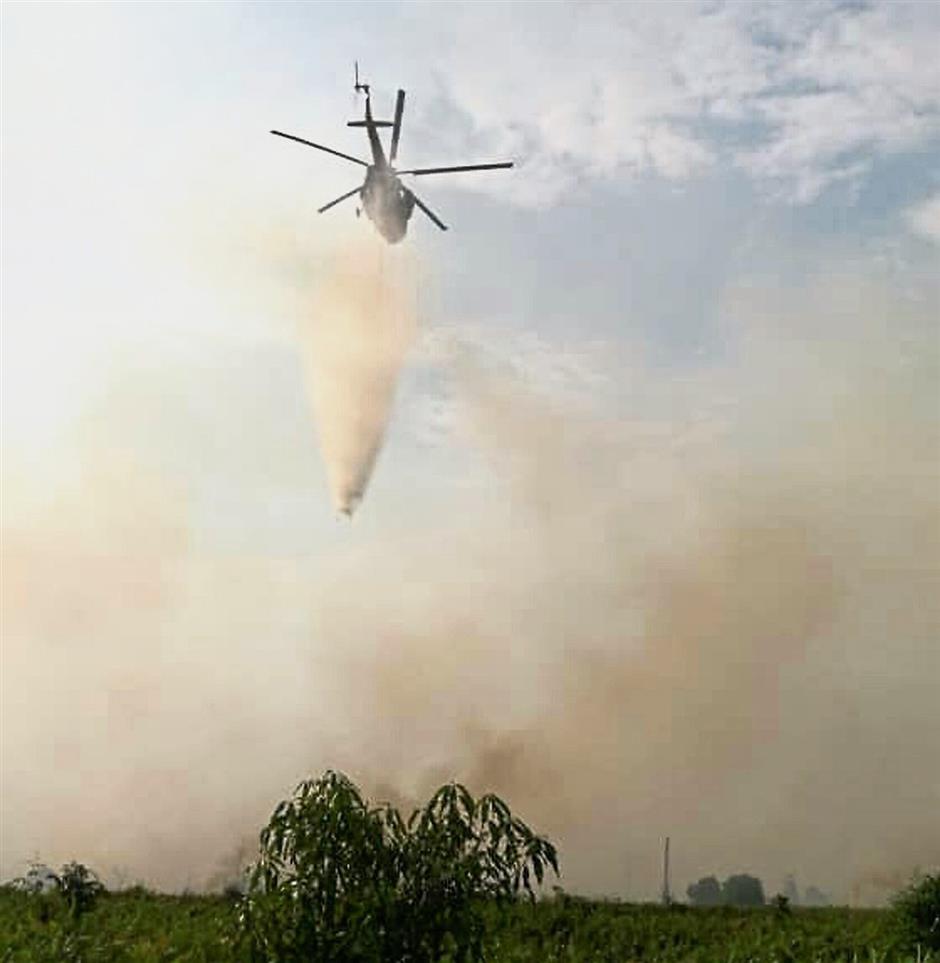 Bomba Miri air unit intensifies aerial water-bombing in Kuala Baram district this morning, the second day running as Air Pollutant Index was at 113 unhealthy level this morning. Bomba Miri pic