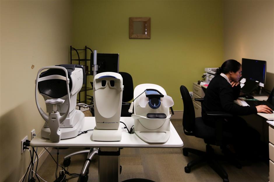 An ophthalmic technician works in an eye exam room at a Cisco health clinic at Cisco Systems in San Jose, California, U.S., March 22, 2018. Picture taken March 22, 2018. REUTERS/Elijah Nouvelage