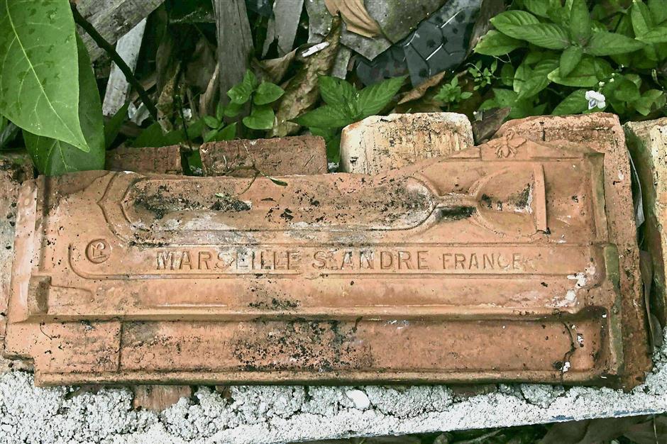 The earthen roof tiles are believed to have been imported from Marseilles, France between 1890 and 1914.
