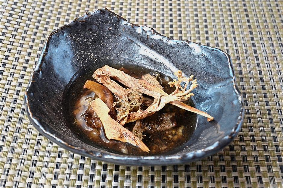 Using a combination of buckwheat and millet grains softened with a chicken stock, the mushroom porridge is topped with deep-fried oyster strips and lychens, pickled and then deep-fried.