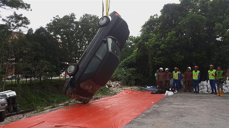 The soil structure is too unstable to tow the vehicles out so the authorities are using a crane to do it.