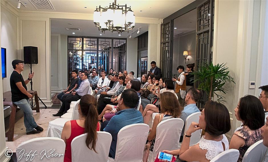 Loh giving a talk to guests during a private viewing of the exhibition at the E&O Hotel.