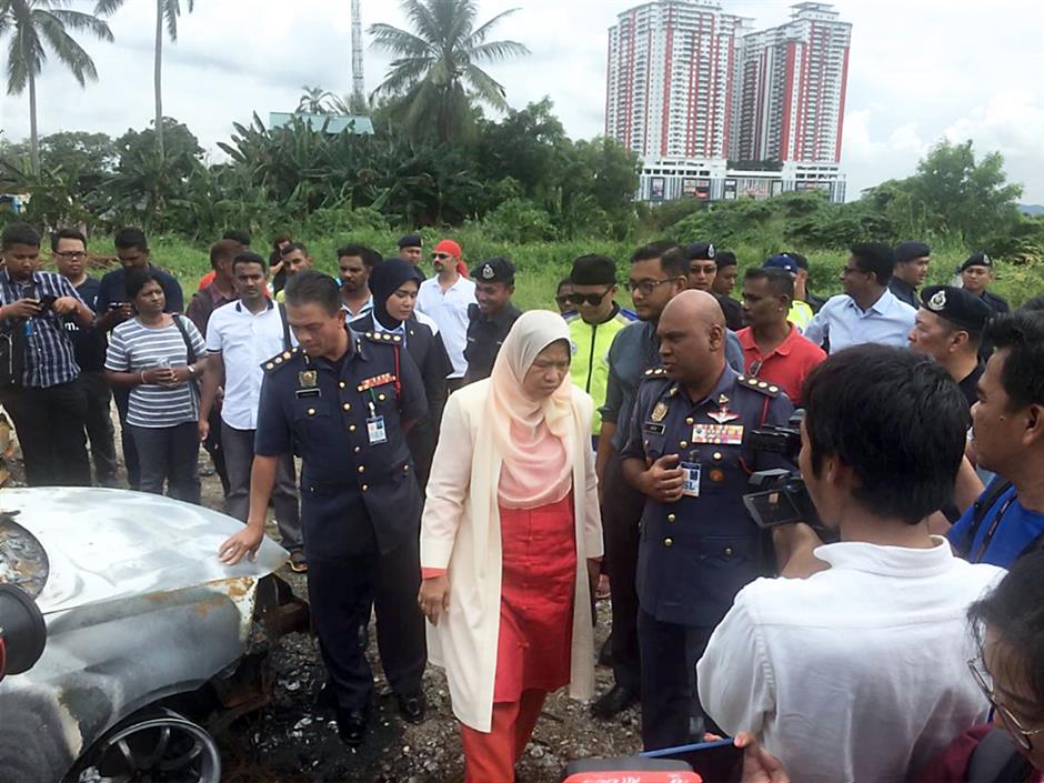 Ongoing investigation: Zuraida (centre) inspecting the scene of the incident outside the Seafield Sri Maha Mariamman Temple in Subang Jaya.