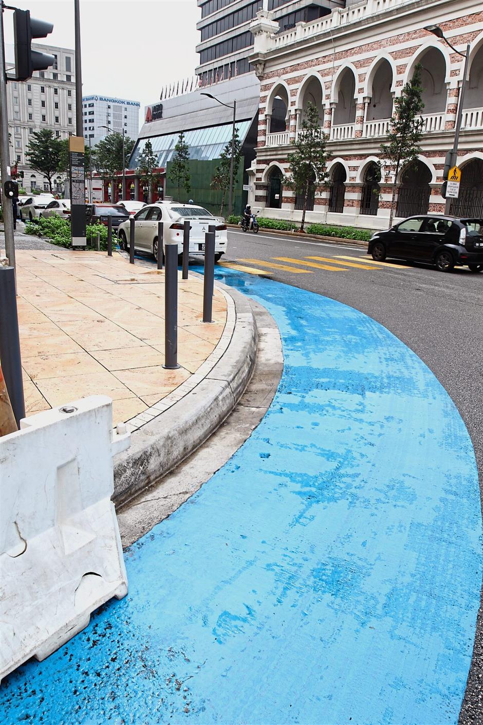It is common to see cars parked on the blue lane designated for cyclists in Kuala Lumpur.