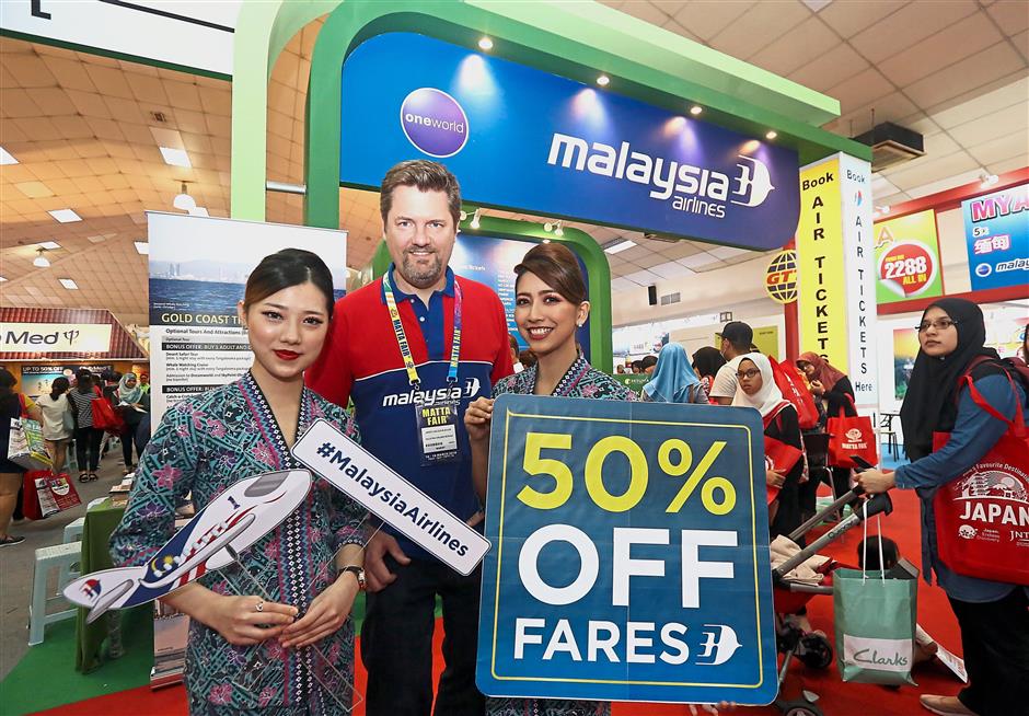 Muehlen (centre) at the Malaysia Airlines booth where discounts up to 50 on selected routes were offered to travellers.