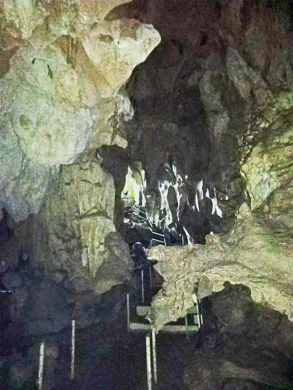 The descent into the darkness of Gua Terang Bulan.