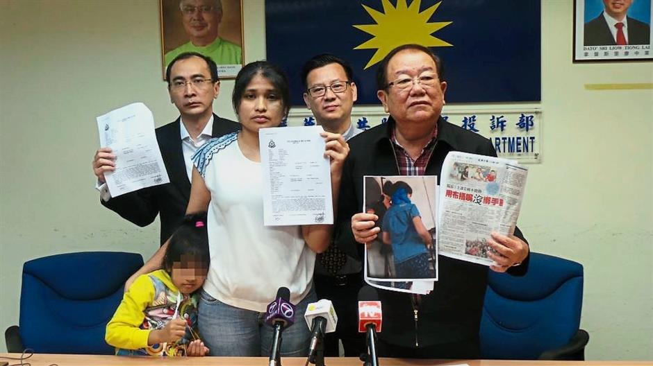 Unacceptable punishment:(From left) The victim, Teng and Chong showing copies of Teng’s police report and pictures of the punishment ?at Wisma MCA?. Looking on are Chong’s lawyers, James Ee (left, back row) and Leong.
